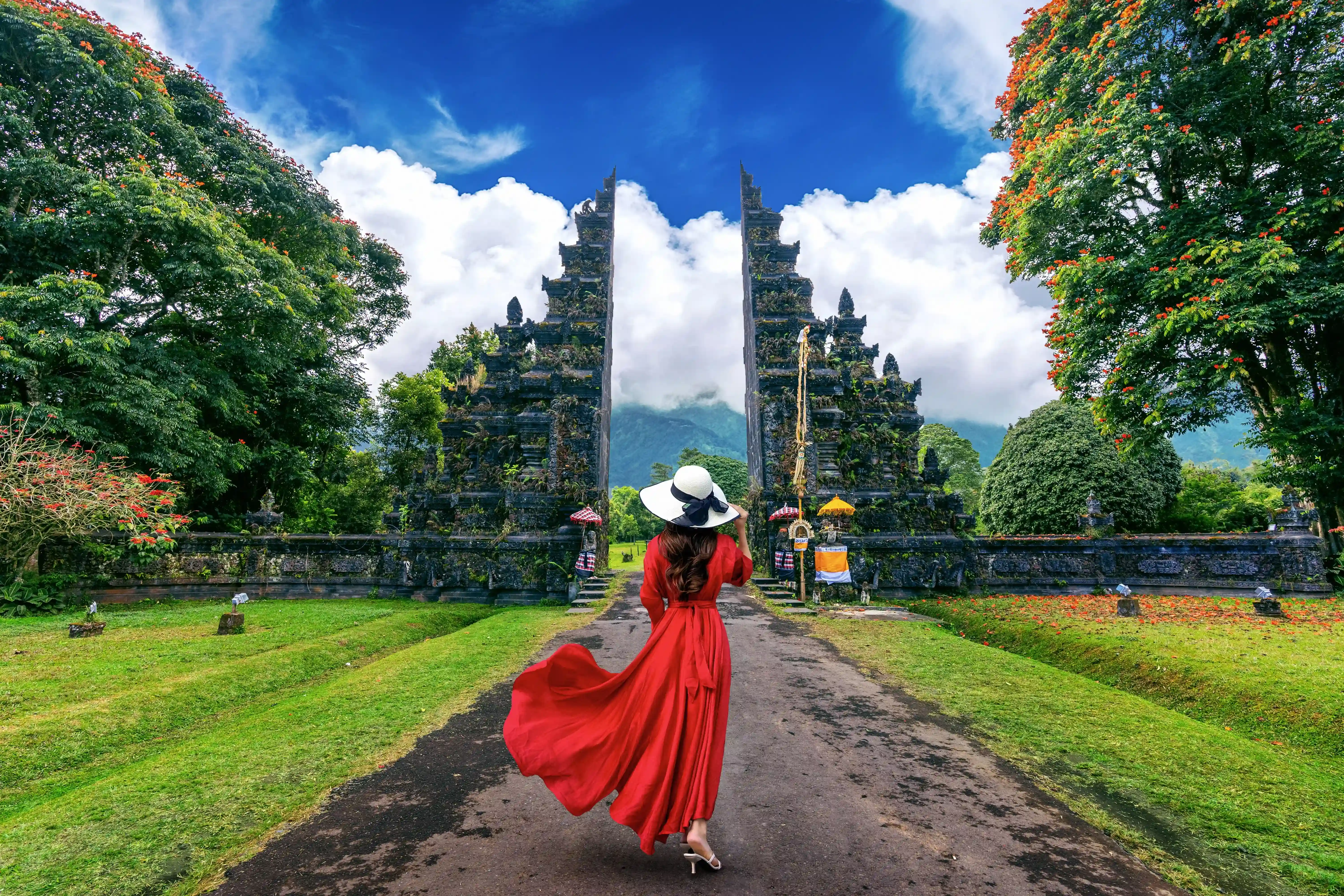 Girl with red dress in beautiful landscape